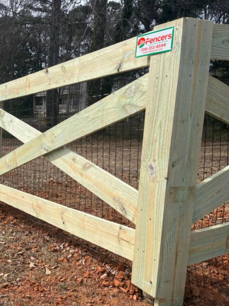 Professional Wood Fence in Athens, GA, Fence contractor measuring grade and alignment before installing durable posts with specialized tools