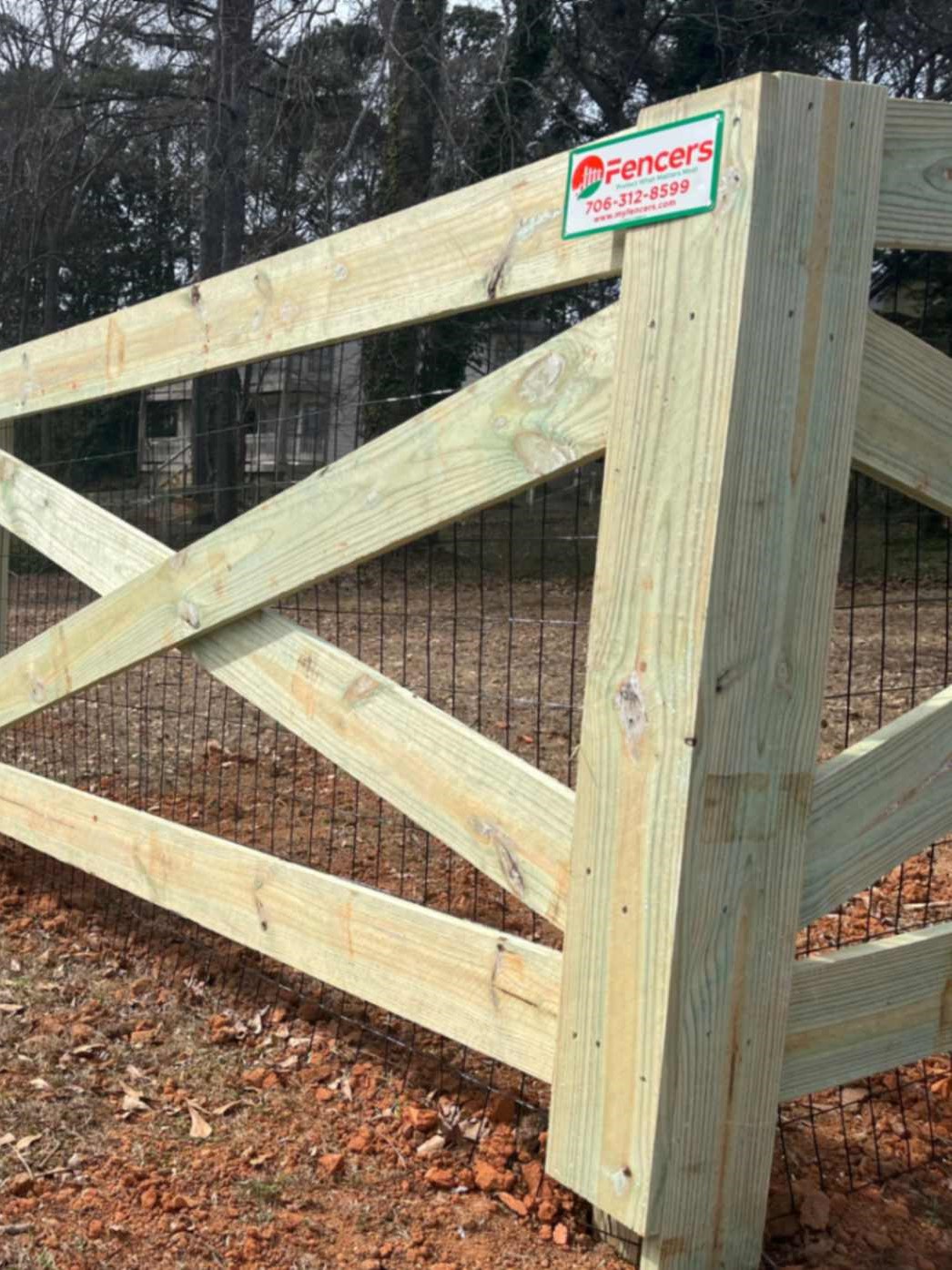 Professional Wood Fence in Athens, GA, Fence contractor measuring grade and alignment before installing durable posts with specialized tools