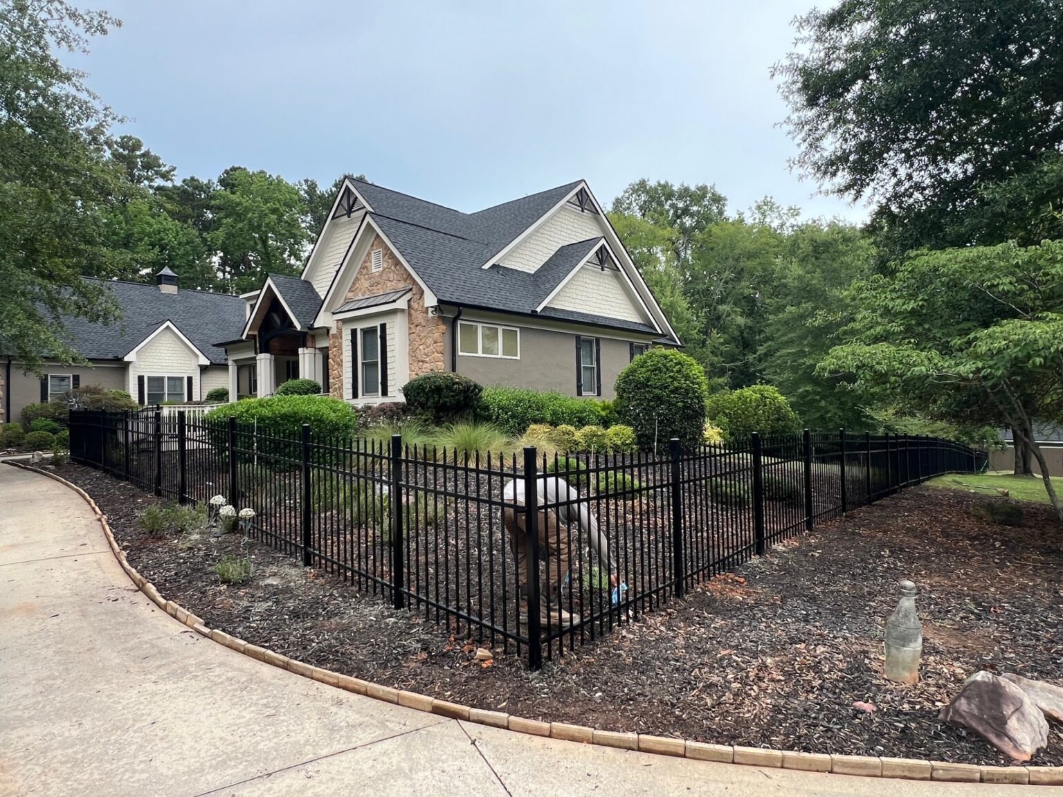 Fence professional measuring post spacing and checking grade before installation