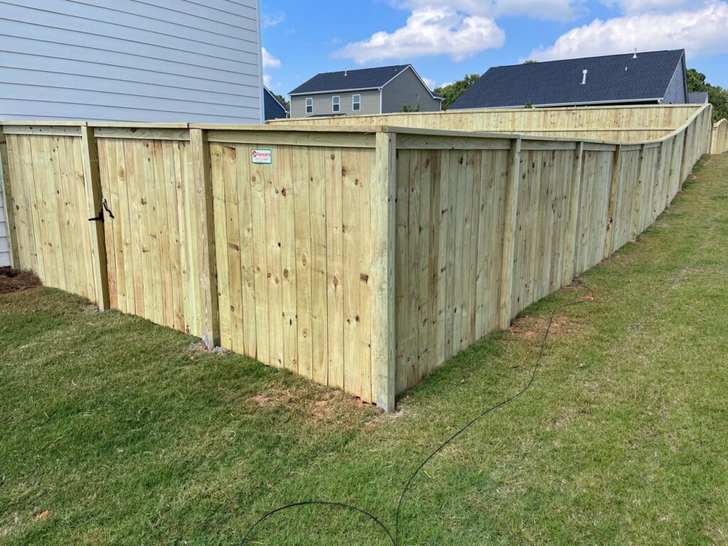 Installer checking fence post depth and alignment for long-lasting boundary stability