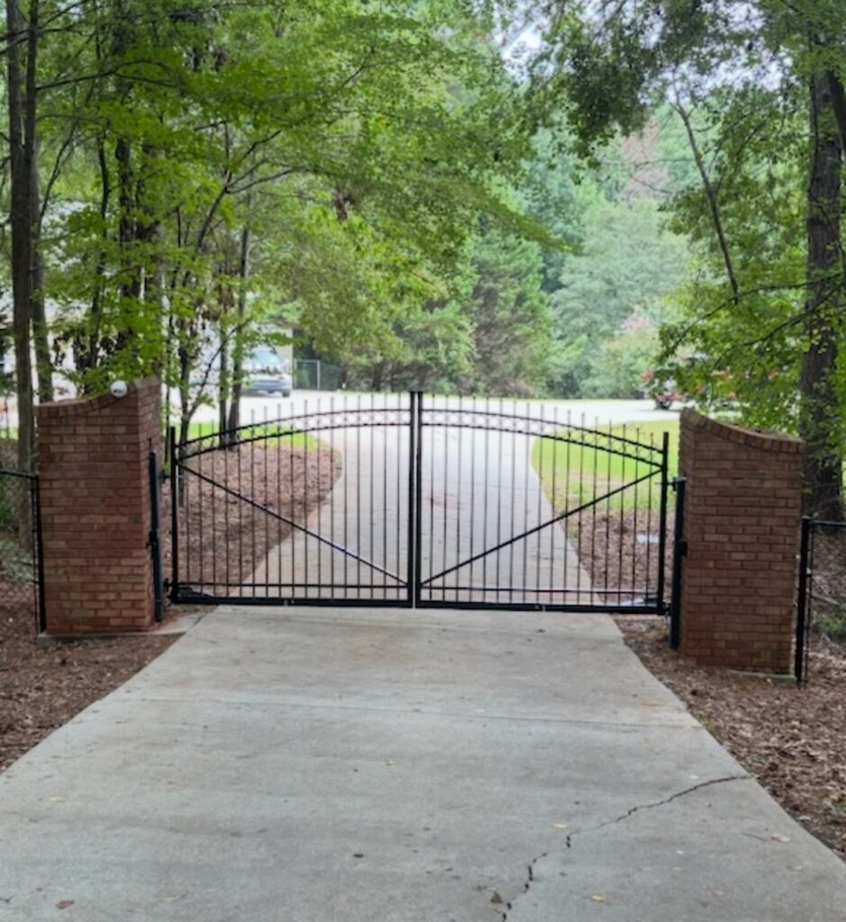 Fence professional reviewing property lines and gate placement before residential installation