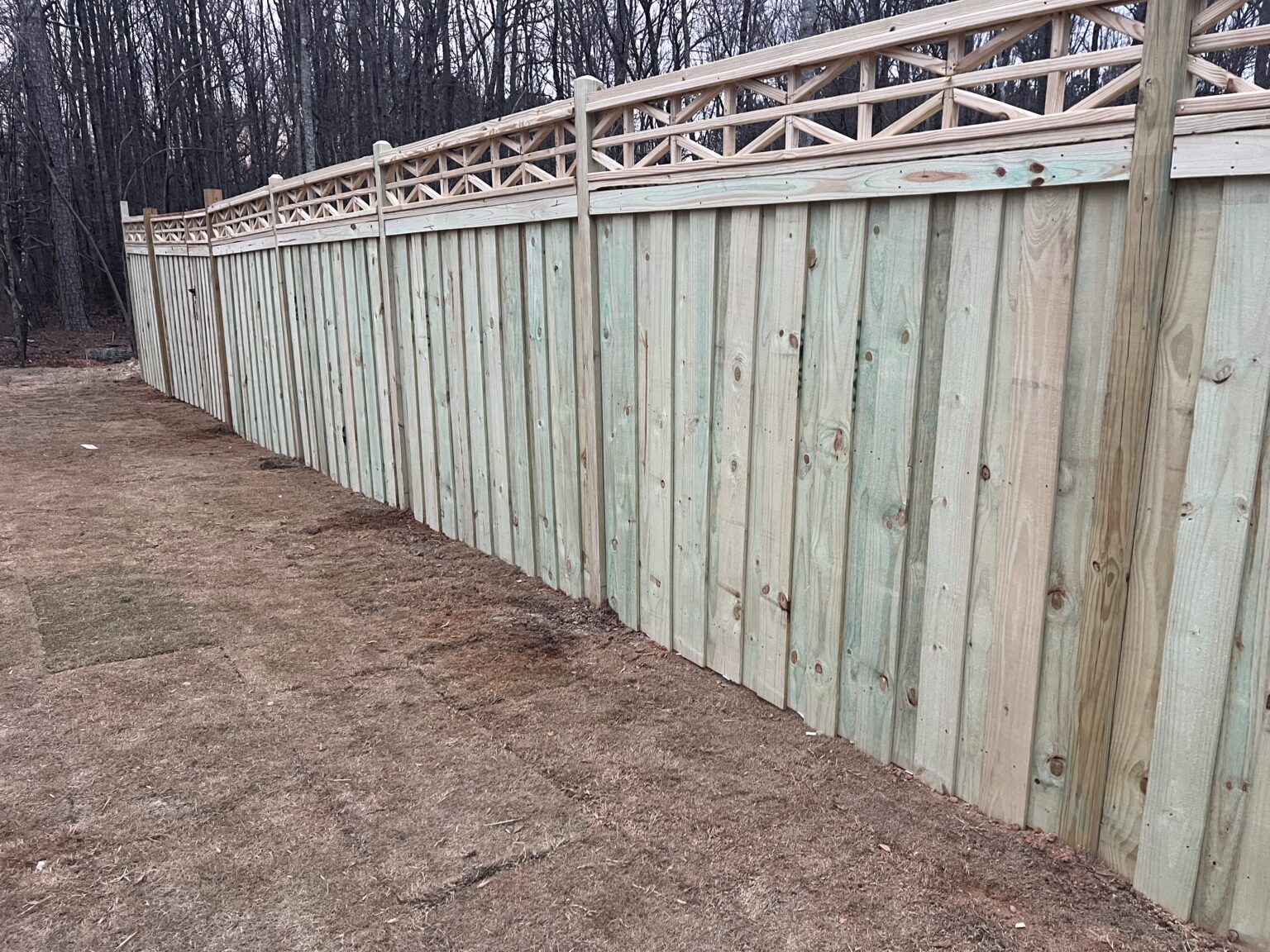 Fence professional measuring layout lines and checking straight post spacing