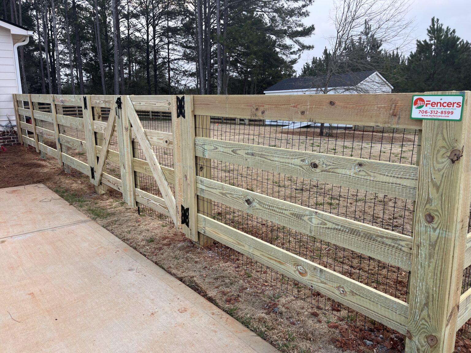 Fence professional measuring straight boundary line with level and marking tools
