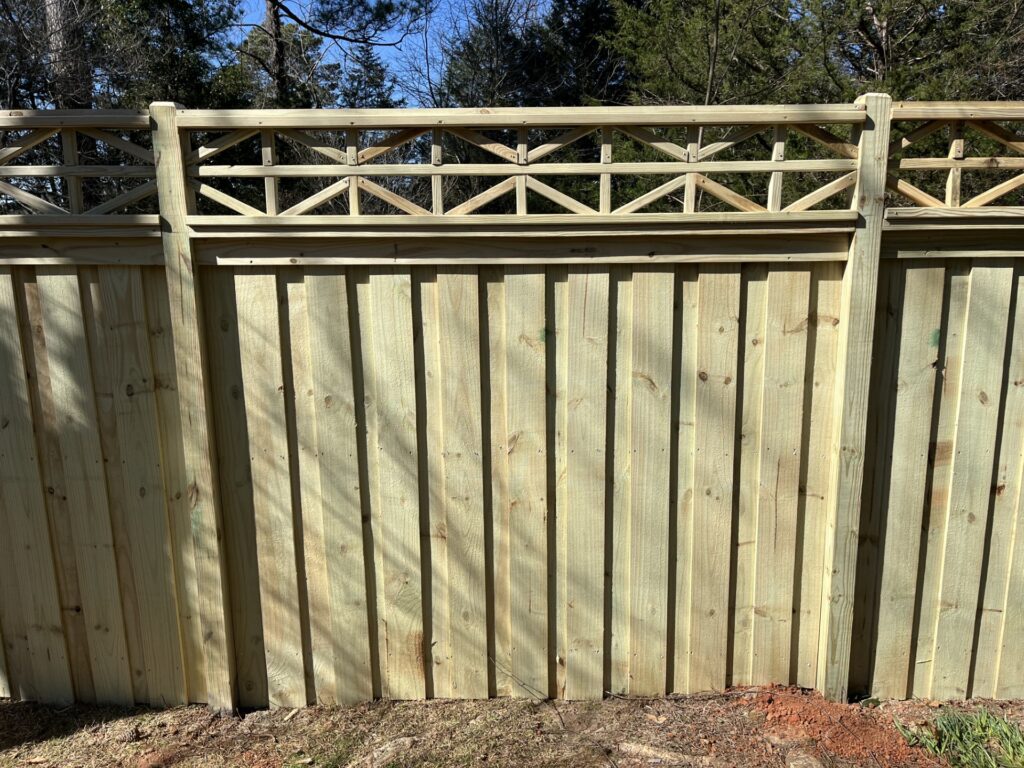 Experienced fence specialist checking level posts and secure gate hardware on site
